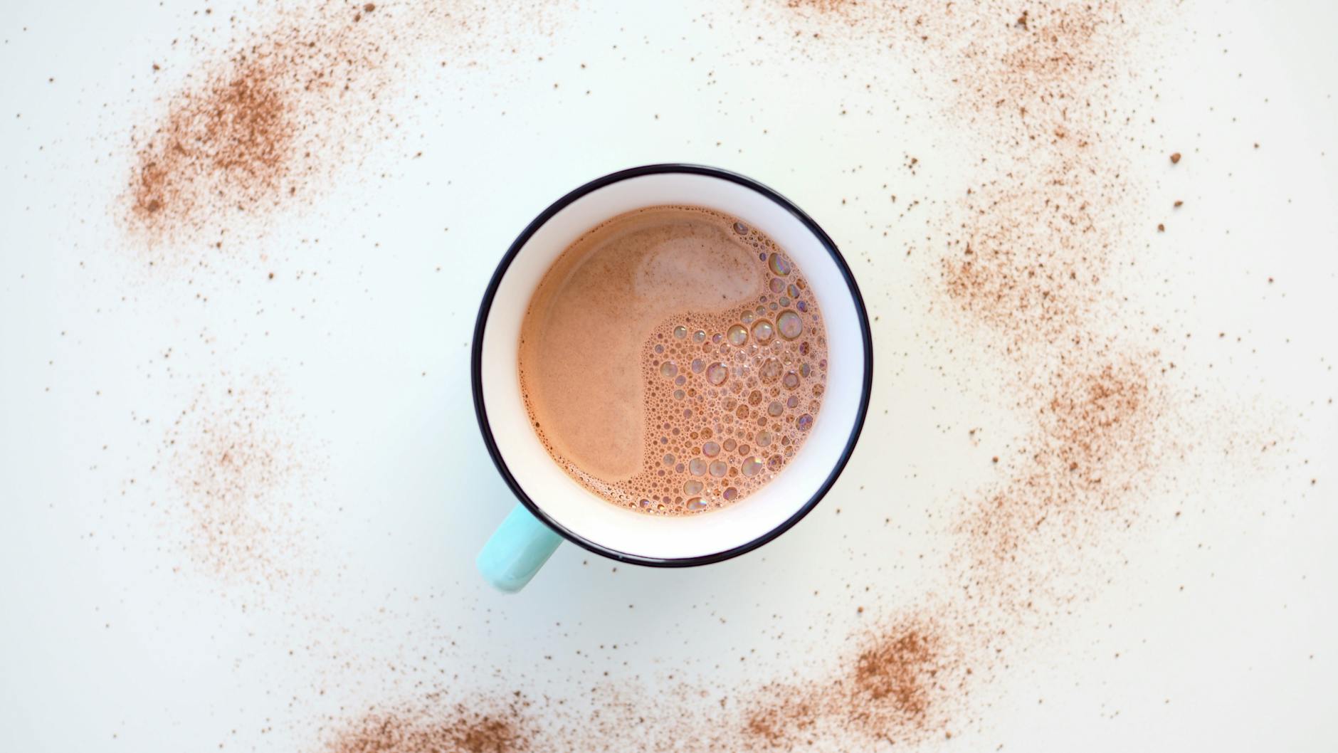 white ceramic mug with brown liquid