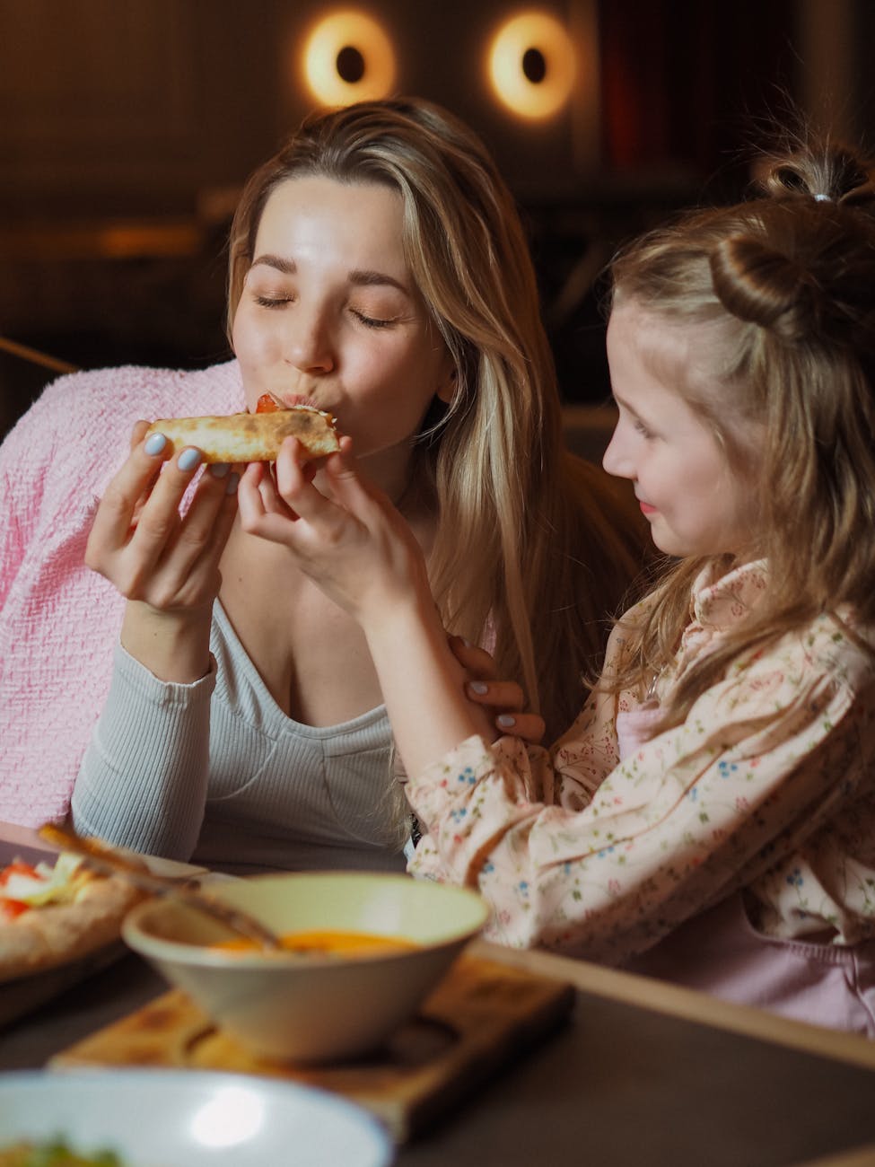 girl feeding a woman